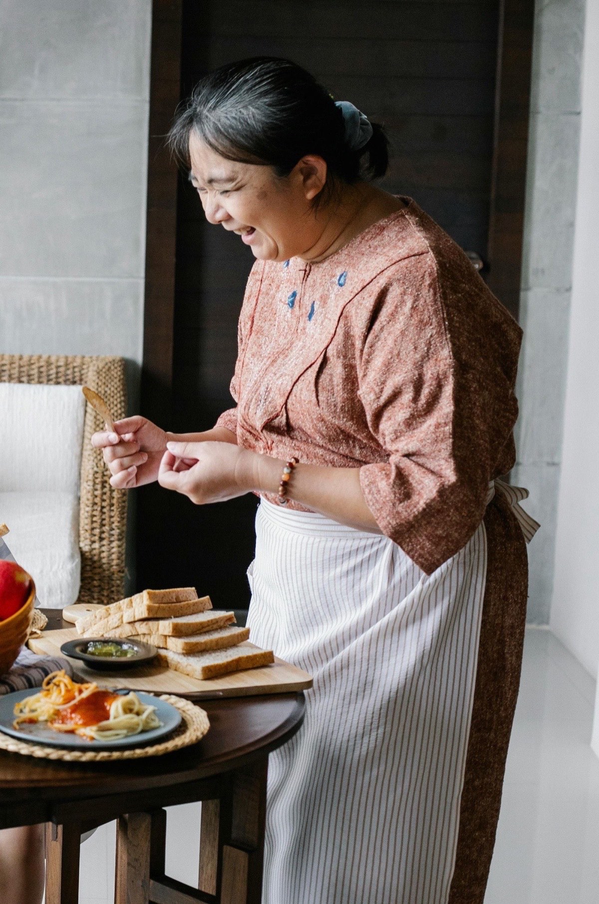 Older woman joyfully cooking at home, enjoying quality care